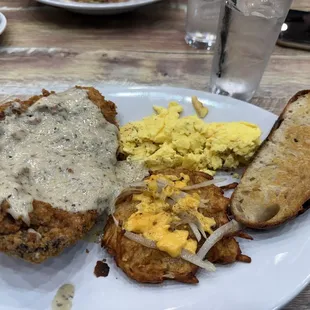 Prime rib deep fried with gravy, hash browns and eggs and sourdough bread.