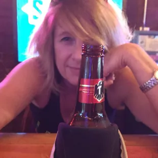 a woman holding a beer bottle