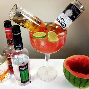 a watermelon and a bottle of alcohol