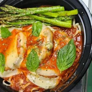 Eggplant Parmesan over Linguine pasta with Asparagus.
