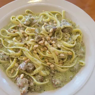 Fettuccine with sausage, pesto, and pine nuts