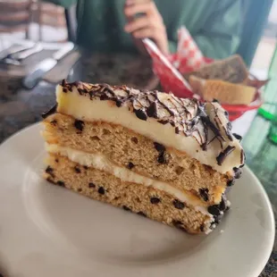 Slice of their Chocolate Chip Cake, cream cheese frosting (4/6/23)
