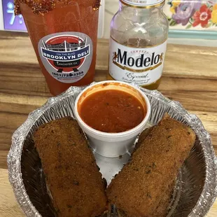 a bowl of sauce and a bottle of beer