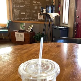 Iced decaf latte with almond milk and a bit of stevia, at a comfortable table