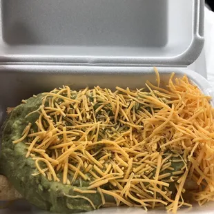 3 rolled tacos with guacamole and cheese