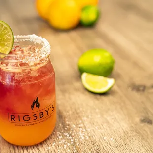 a drink with a lime garnish