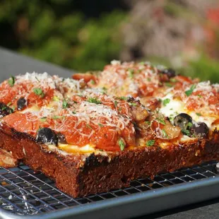 a pizza on a cooling rack