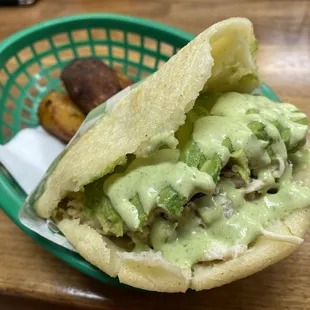 Reina Arepa with lots of green sauce