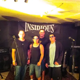 a group of people standing in front of a microphone