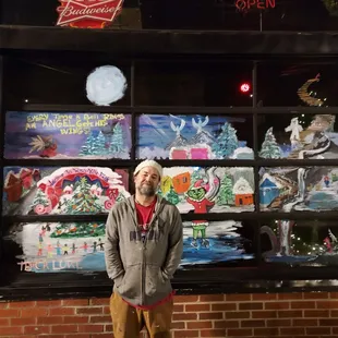 a man standing in front of a window