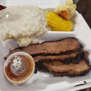 Single meat plate with brisket, corn on the cob and mashed potatoes and gravy
