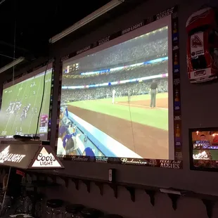 2 Big giant screen tv&apos;s on top of pool tables...