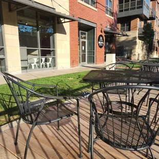 a patio with tables and chairs