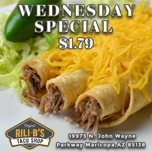 a plate of burritos with shredded cheese