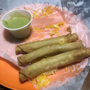 3 Rolled Chicken Tacos with Cheese and Guacamole