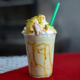 a milkshake topped with whipped cream and caramel