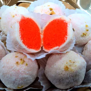 a plate of doughnuts with a red heart cut in