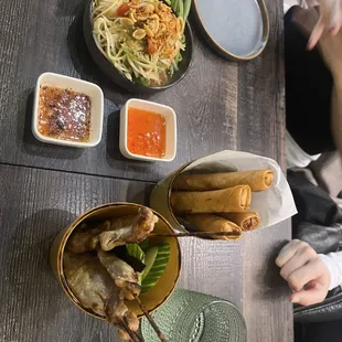Papaya salad, spring rolls and marinated pork with tamarind sauce.