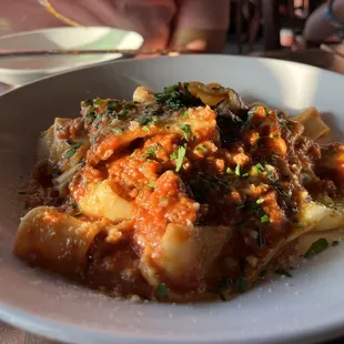 a plate of pasta with meat and vegetables