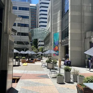 a view of a courtyard with tables and chairs