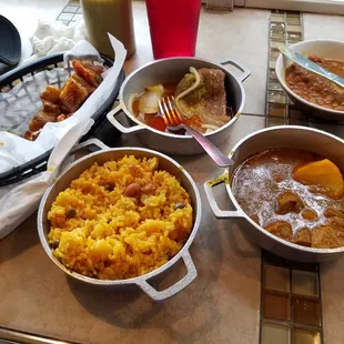Steak, beef stew, yellow rice, beans,chicharrón. Can't even eat half