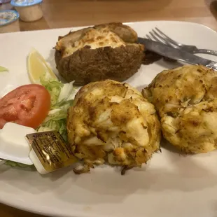 2 Crabcakes with a baked potato.