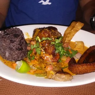 Mar y tierra plate. NY steak with 2 shrimp skewers in a yucatan salsa with black rice, veggies, yucca and plantain.