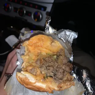 a person holding a sandwich