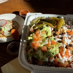 A gorgeous meal (super nachos with carne asada, taco with carnitas)