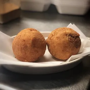 two fried donuts on a plate