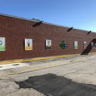 a brick building with posters on it