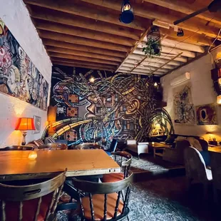 a dining room with a mural on the wall