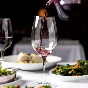 a wine being poured into a wine glass