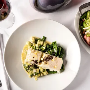 a plate of food and a glass of wine