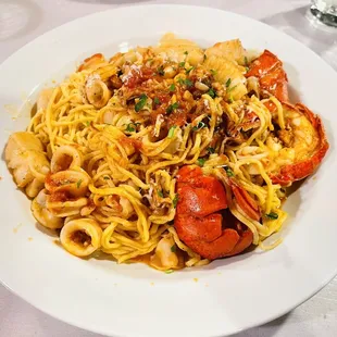 Scallop, calamari, and lobster tail with spaghetti noodles