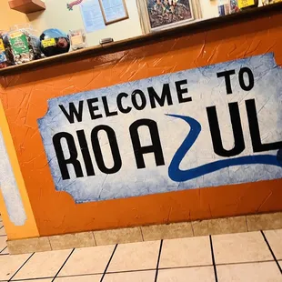 a welcome to rio azul sign
