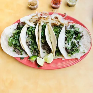 three tacos on a red plate