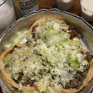 a pizza with lettuce and cheese