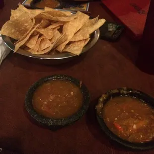 a man eating a meal with tortillas and salsa