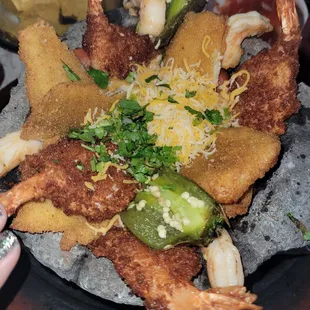 Seafood molcajete came with rice beans Pico de gallo guacamole sour cream and tortillas on the side