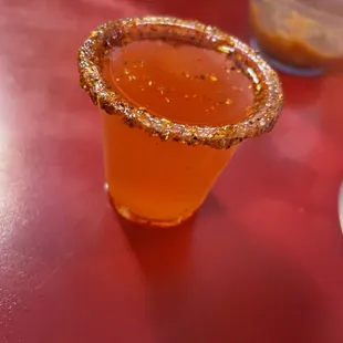 a close up of a drink in a shot glass