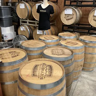 a display of barrels and a mannequin