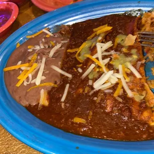 Cheese n onion enchilada with Refried beans came with rice I&apos;ve already ate the rice good food