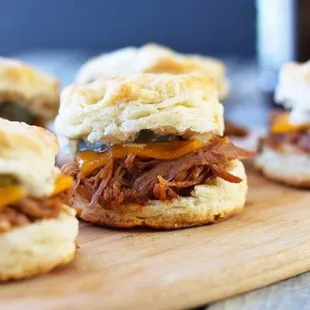 pulled pork and cheese biscuits on a cutting board