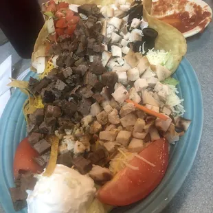 a plate of mexican food and a drink