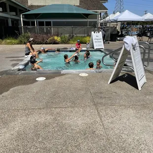 15 children and 2 adults squashed into this jacuzzi.