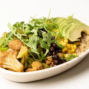 a bowl of salad with cauliflower, black beans, and avocado