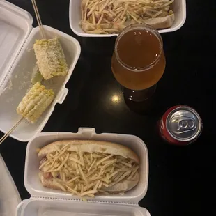 a hot dog, corn, and a beer