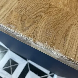 They chipped the counter top while cutting it and then ruined it further by sanding it in an effort to hide the chips