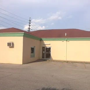 a yellow building with a red roof